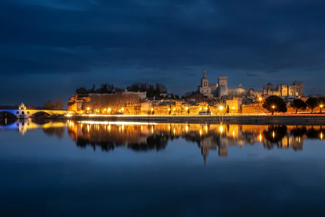 Avignon at blue hour reflected in the Rhône.