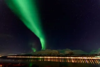 Northern lights over the Solenagen fjord in front of the Lyngenfjord Alps